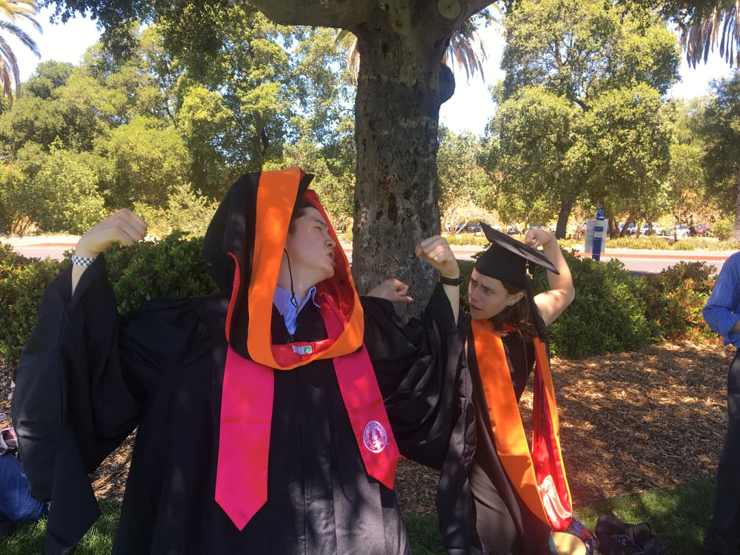 John and Caitlin flexing during graduation photo shoot
